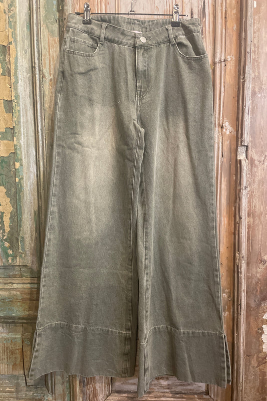 Pair of green pants on a wooden surface