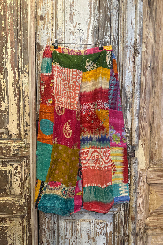 Colorful patchwork fabric on a wooden surface