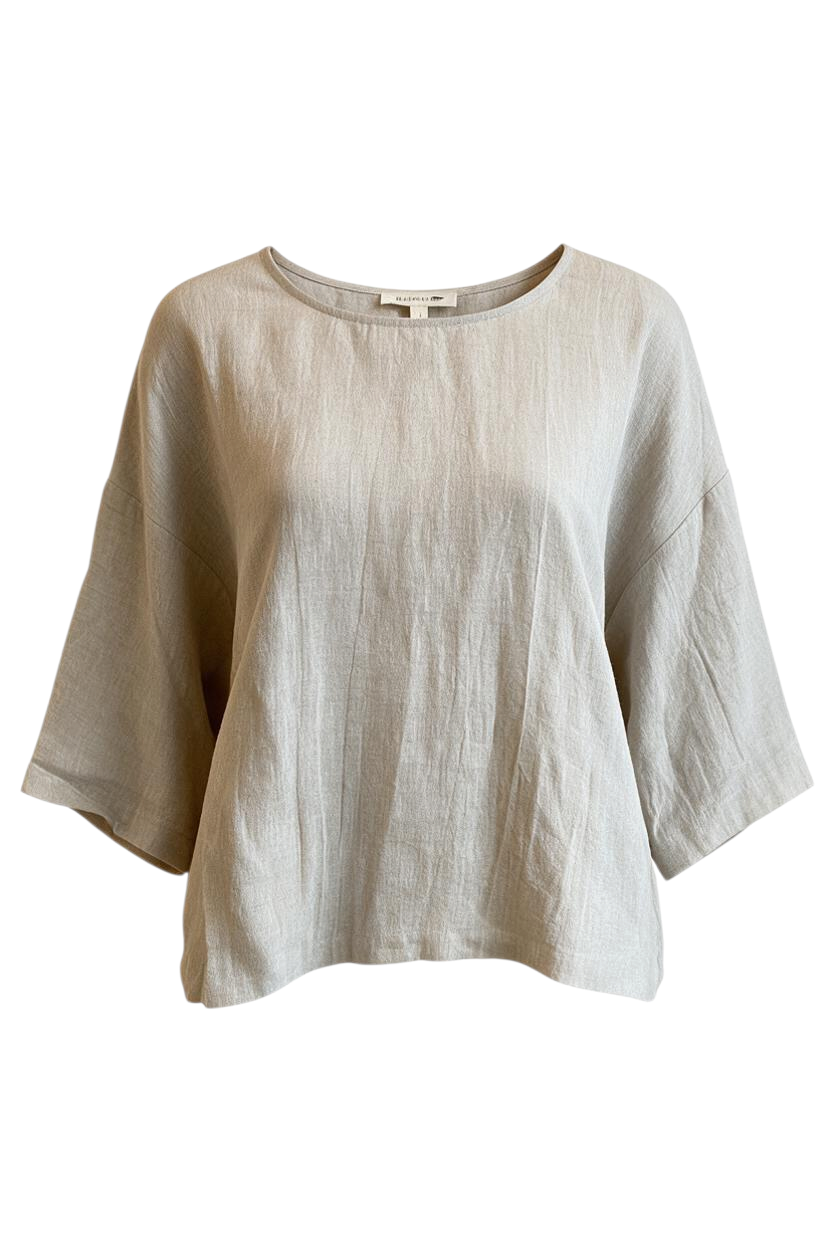 Trestles Clothing Company boxy linen top in natural beige with a scoop neck and 3/4 sleeves on a hanger