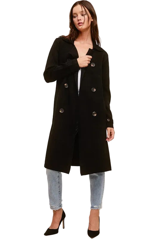 Model wearing a black Trestles Clothing Company Beckham midi sweater coat over jeans and black heels