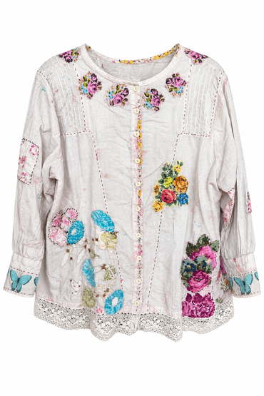 Trestles Clothing Company vintage-inspired white cotton blouse featuring hand-stitched floral patches and lace hem.