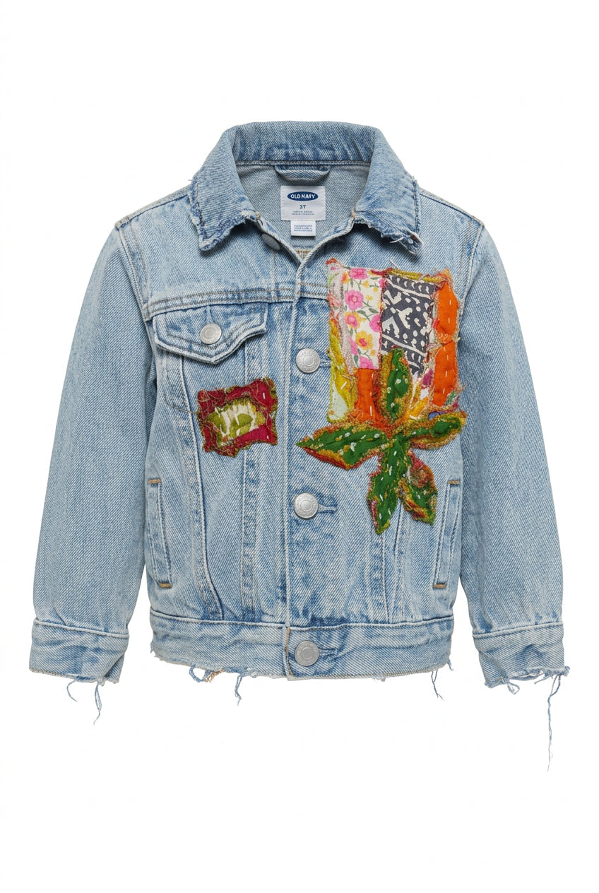 Trestles Clothing Company upcycled denim baby jacket with vibrant Indian Kantha patchwork and distressed hem details.