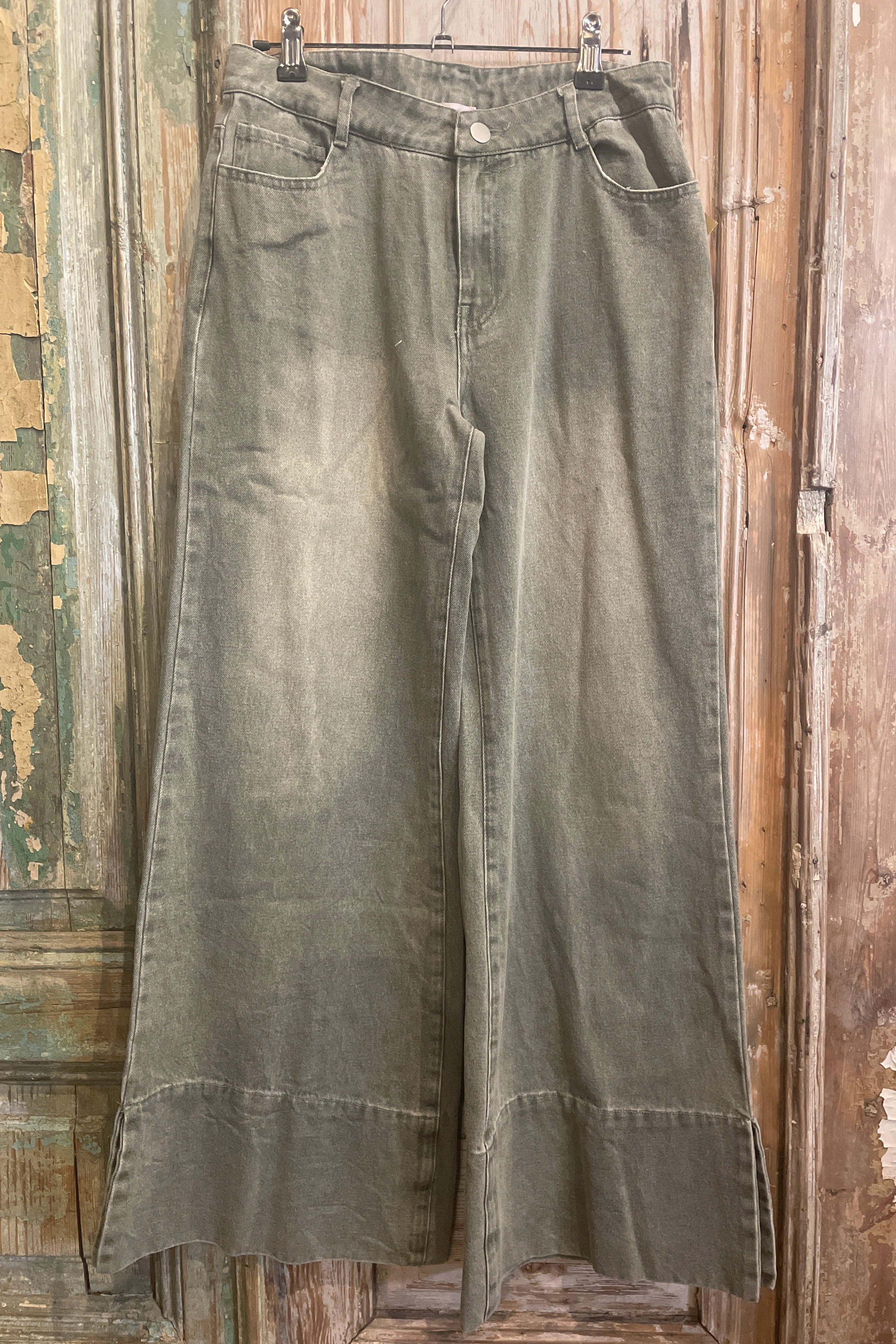 Pair of green pants on a wooden surface