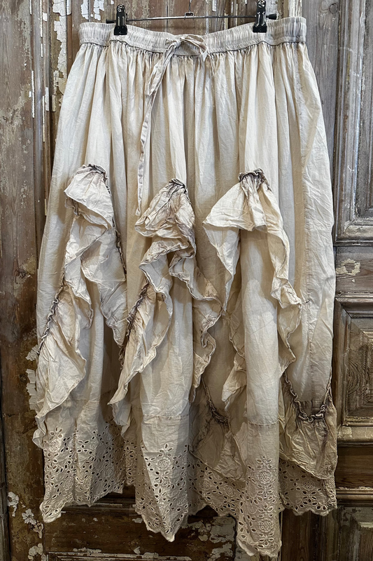 Vintage lace skirt hanging against a wooden door