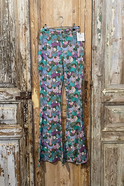 Floral-patterned pants hanging on a wooden door