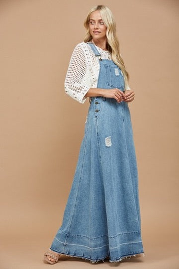 Trestles Clothing Company 70s inspired light wash denim maxi overall dress with distressed details and wide skirt