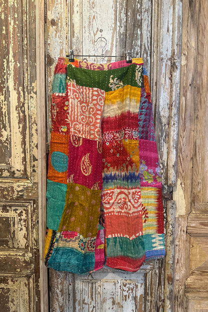 Colorful patchwork fabric on a wooden surface