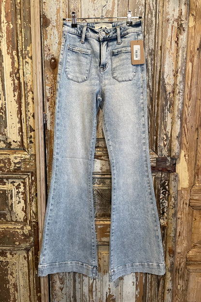 Light blue jeans hanging on a wooden door