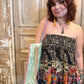 Woman holding a colorful bag against a wooden background