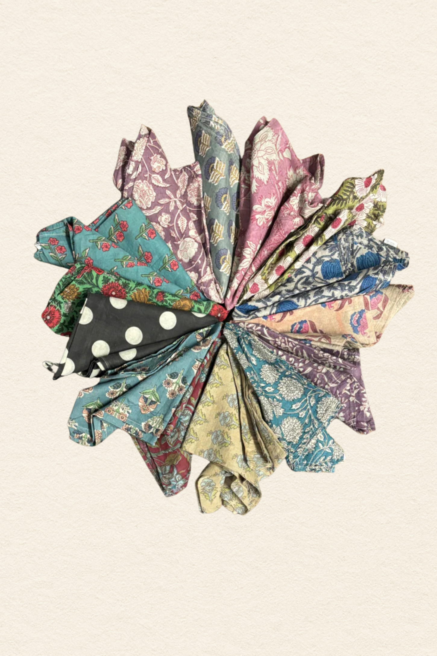 Colorful fabric flowers arranged in a circular pattern on a beige background