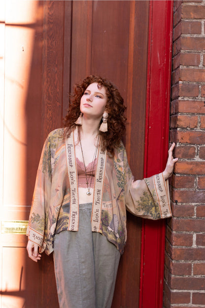 Trestles Clothing Company bamboo cropped kimono with vintage print worn by a woman against a brick wall