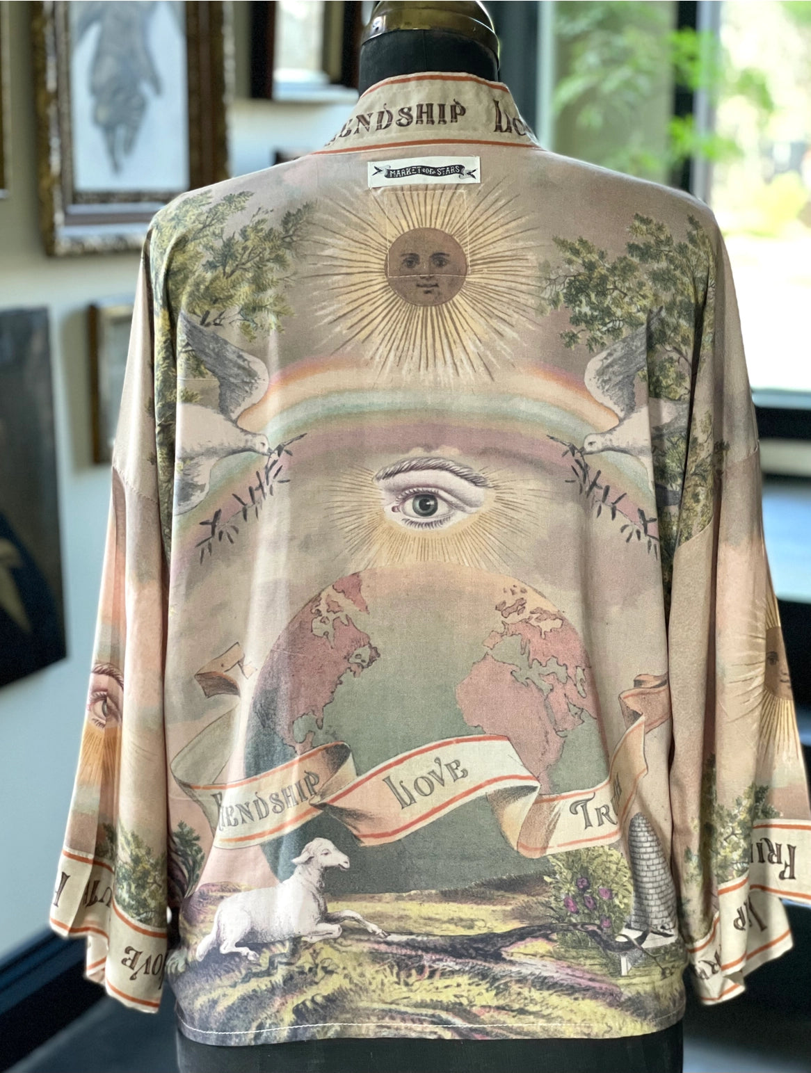 Trestles Clothing Company cropped kimono in bamboo fabric featuring a vintage-style globe, eye, and sun back print.