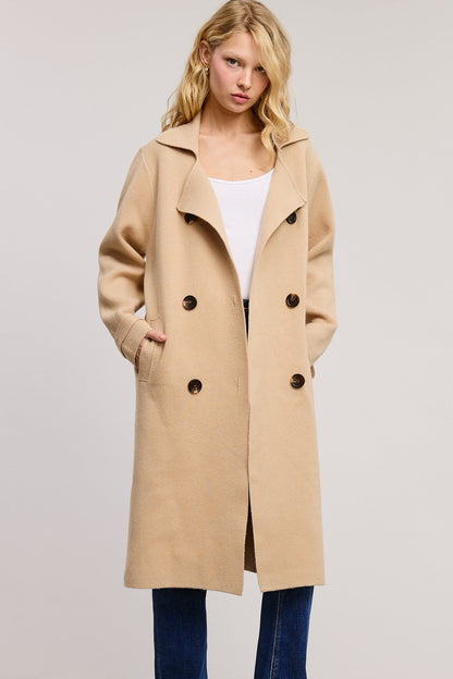 Model wearing a beige Trestles Clothing Company Beckham midi sweater coat in a soft cashmere blend with button front.
