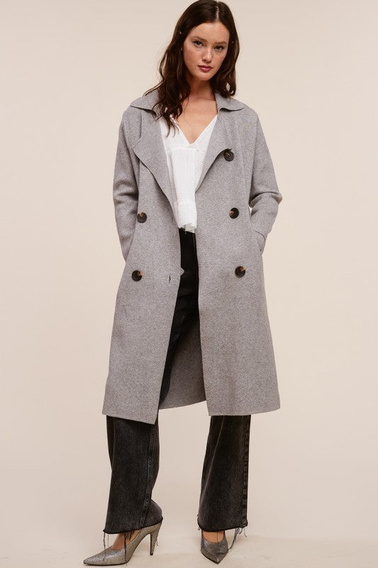 Model wearing a Trestles Clothing Company Beckham Coat in grey cashmere blend with a double-breasted midi silhouette