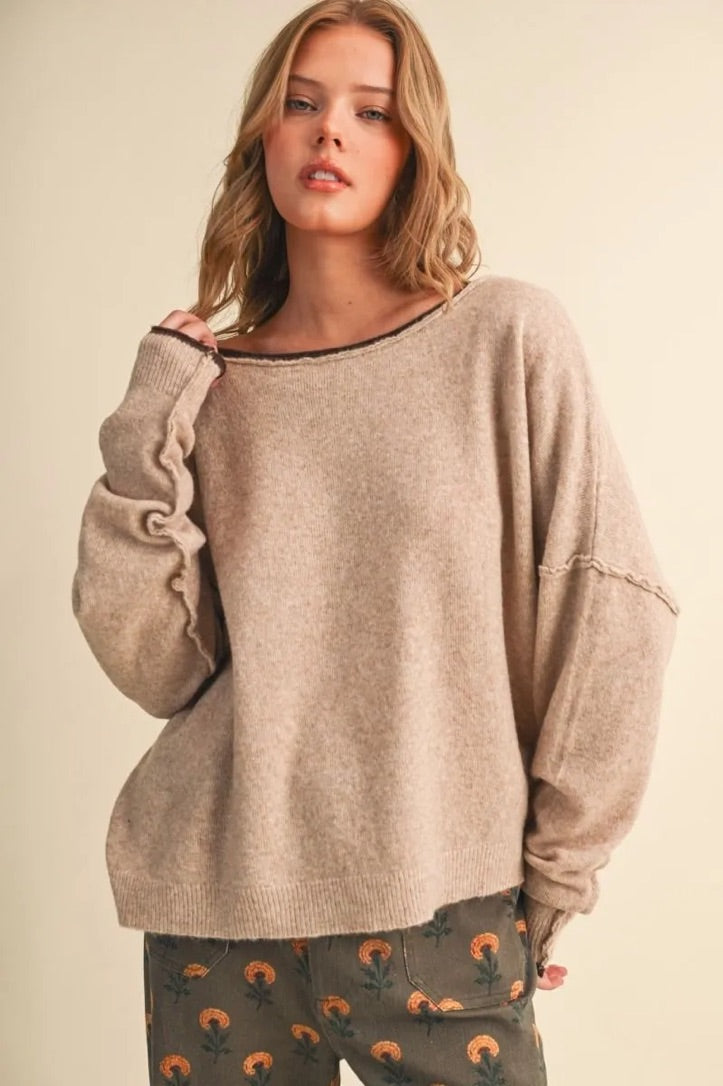 Trestles Clothing Company relaxed beige boatneck sweater with contrast rolled edges and drop shoulder sleeves on model