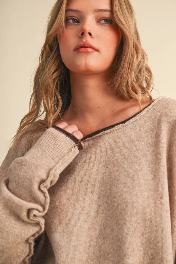 Trestles Clothing Company relaxed beige knit sweater with a boat neckline and dark brown contrast rolled edges