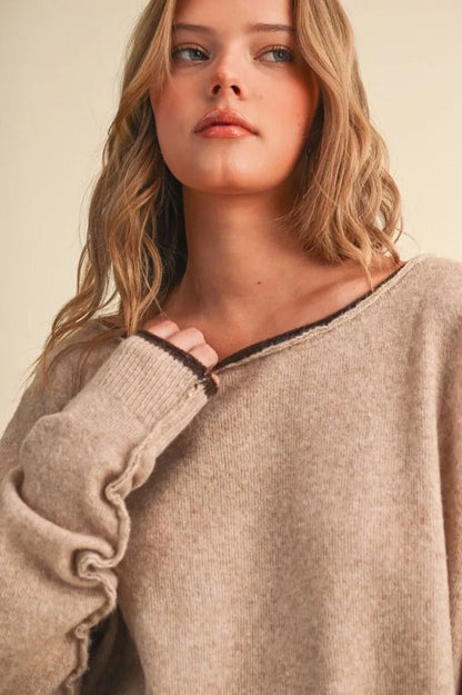 Trestles Clothing Company relaxed beige knit sweater with a boat neckline and dark brown contrast rolled edges