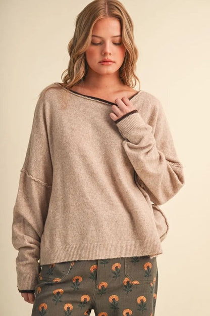 Trestles Clothing Company relaxed beige boatneck sweater with contrast dark trim and drop shoulder sleeves on a model
