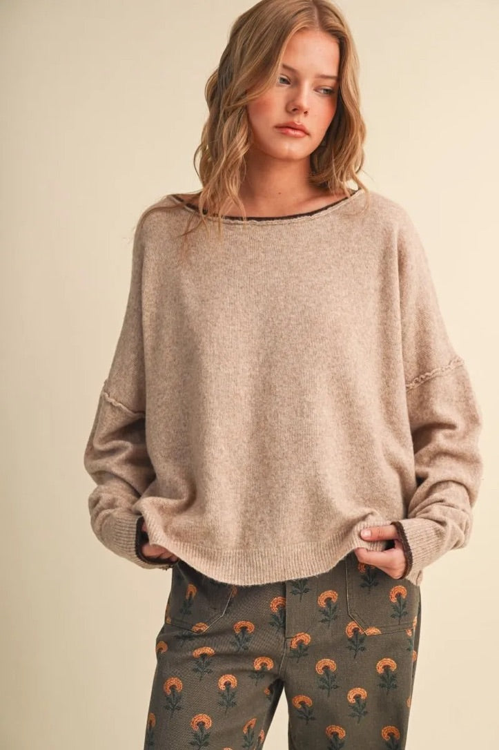 Trestles Clothing Company relaxed beige boatneck sweater with contrast dark trim, drop shoulders, and soft knit fabric.