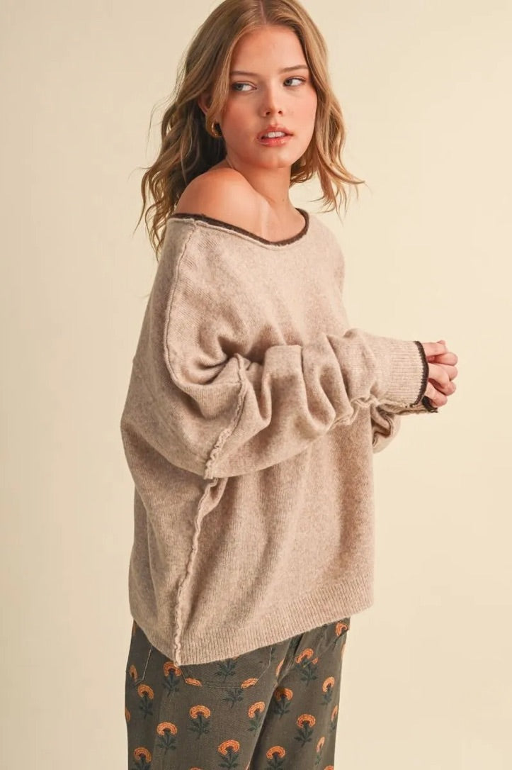 Trestles Clothing Company relaxed beige boatneck sweater with contrast dark trim and drop shoulder sleeves on a model