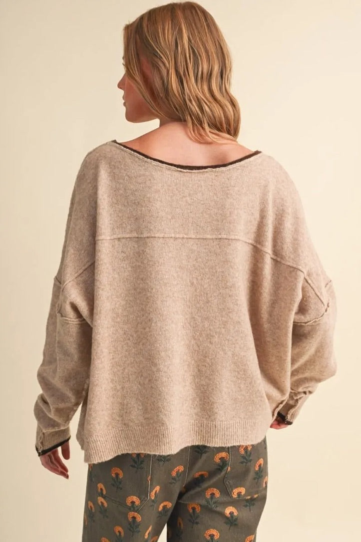 Trestles Clothing Company relaxed beige boatneck sweater with contrast trim and drop shoulders worn by a model