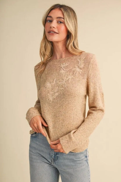 Trestles Clothing Company beige lightweight knit sweater with boat neckline, long sleeves, and tonal floral embroidery.