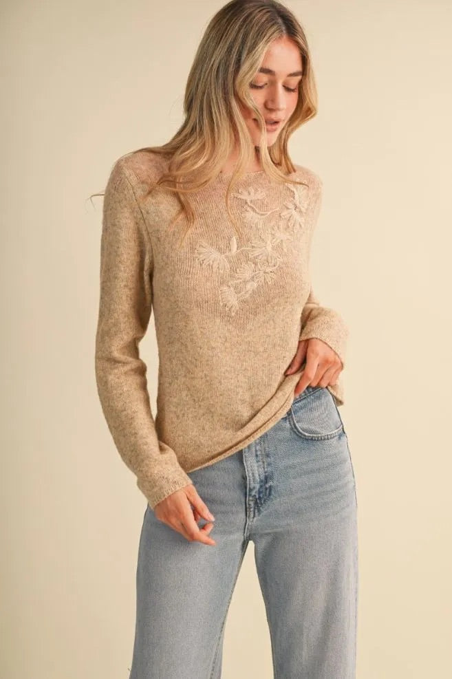 Trestles Clothing Company beige lightweight knit sweater with boat neckline, sheer yoke, and tonal floral embroidery.