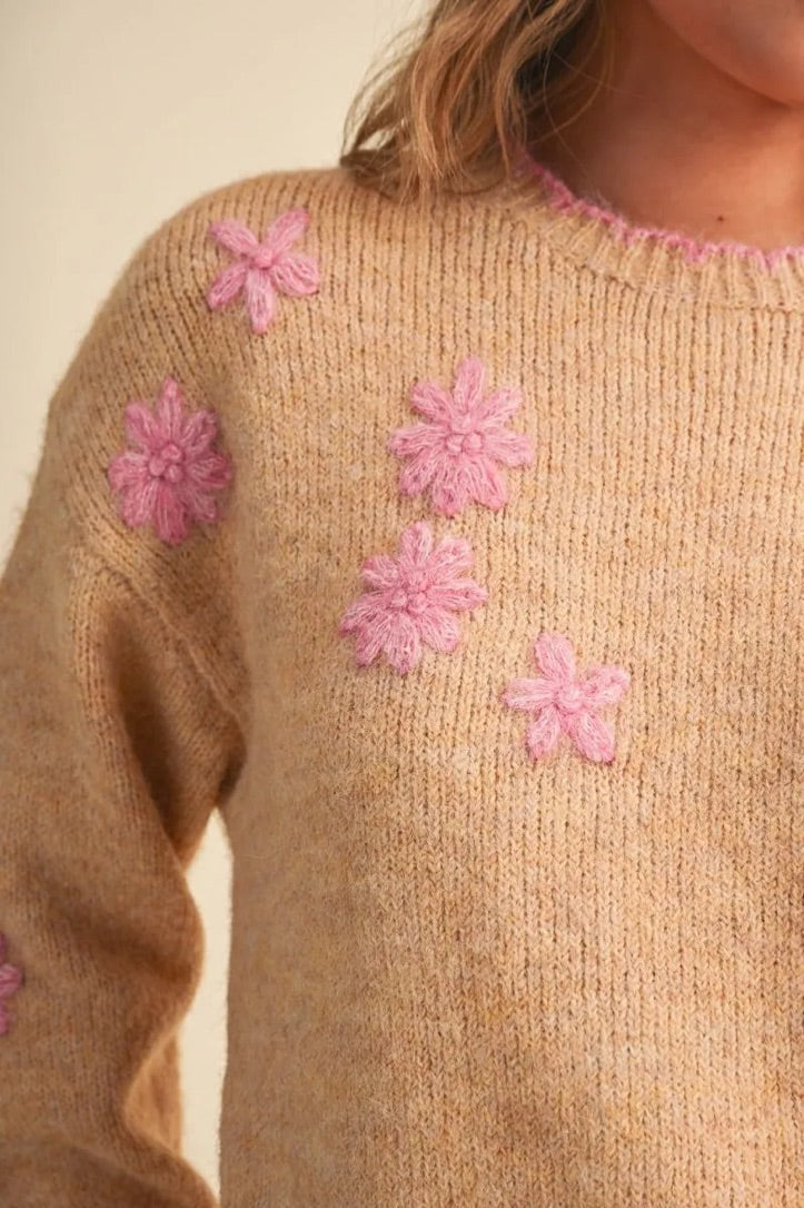 Trestles Clothing Company beige knit sweater featuring pink floral embroidery and a scalloped pink contrast neckline.