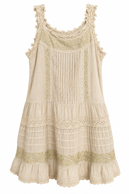 Trestles Clothing Company beige sleeveless dress with intricate lace trim, vertical pleating, and floral embroidery.