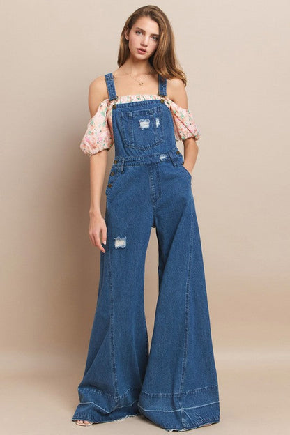 Trestles Clothing Company extreme bell bottom denim overalls with distressed details worn by a model