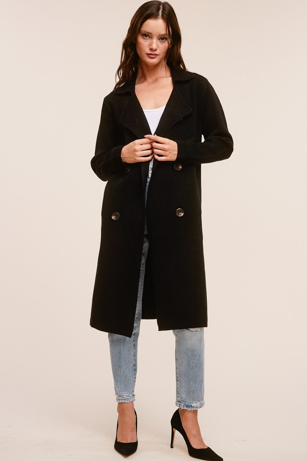 Model wearing a black Trestles Clothing Company Beckham midi sweater coat in a soft cashmere blend with button detail