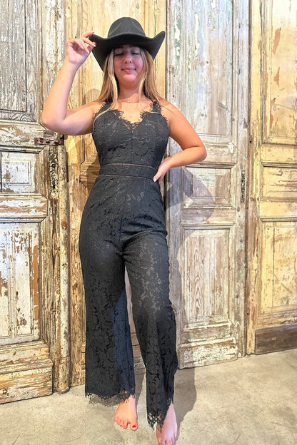 Trestles Clothing Company black lace jumpsuit with strappy back worn with a cowboy hat for a special occasion