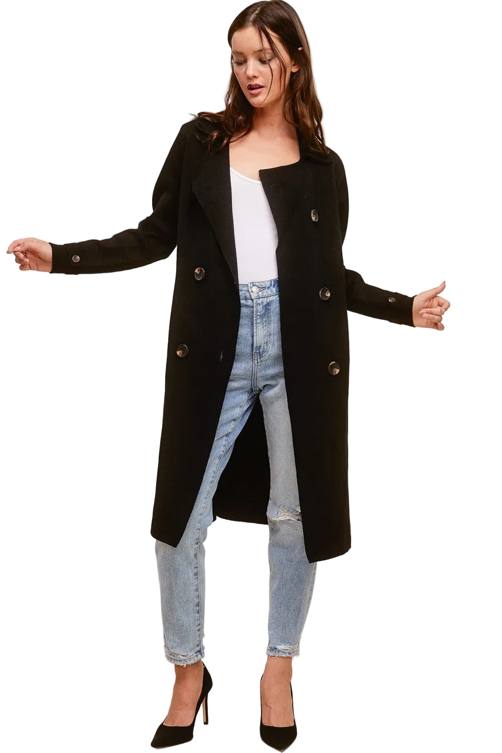 Model wearing a black Trestles Clothing Company Beckham midi sweater coat over a white top and distressed jeans.