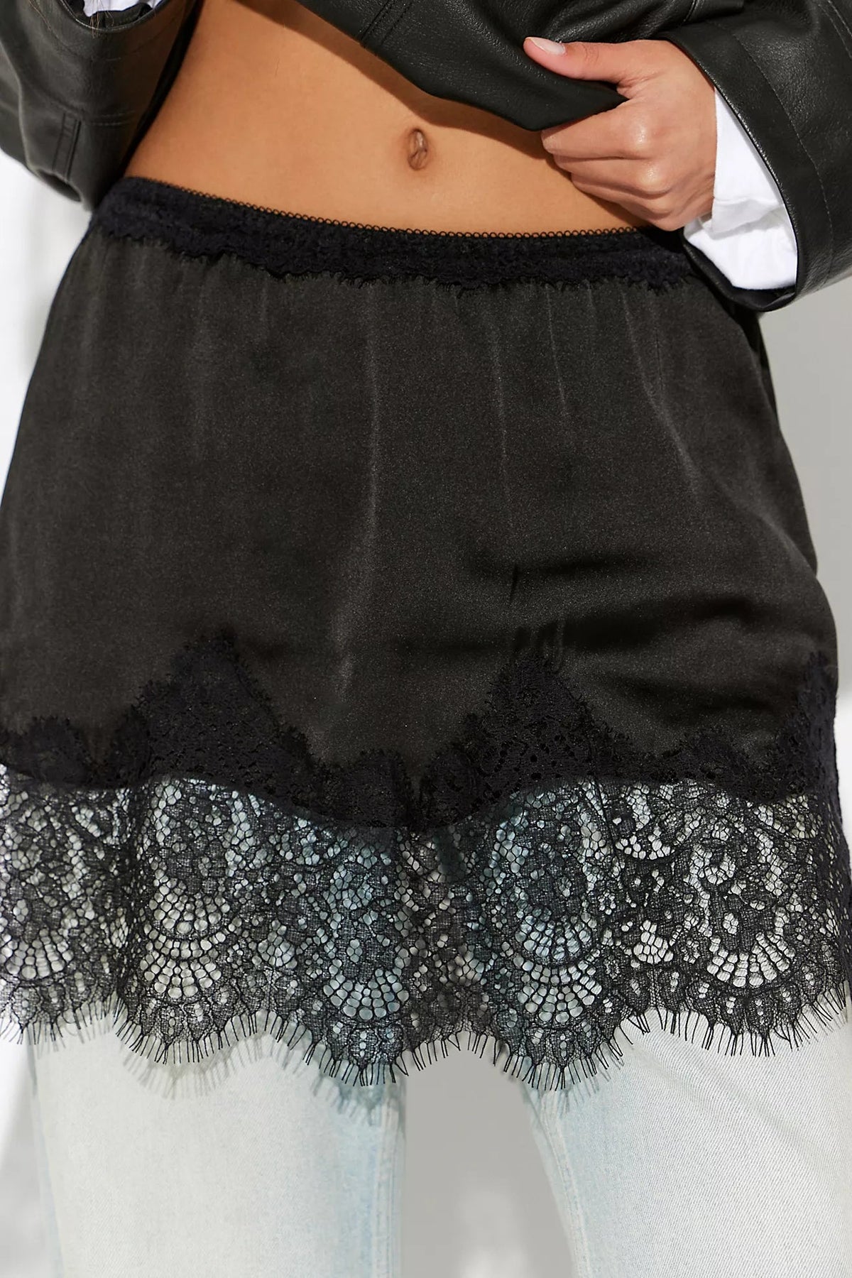 Trestles Clothing Company black satin half slip featuring intricate eyelash lace trim and a mid-rise A-line silhouette.