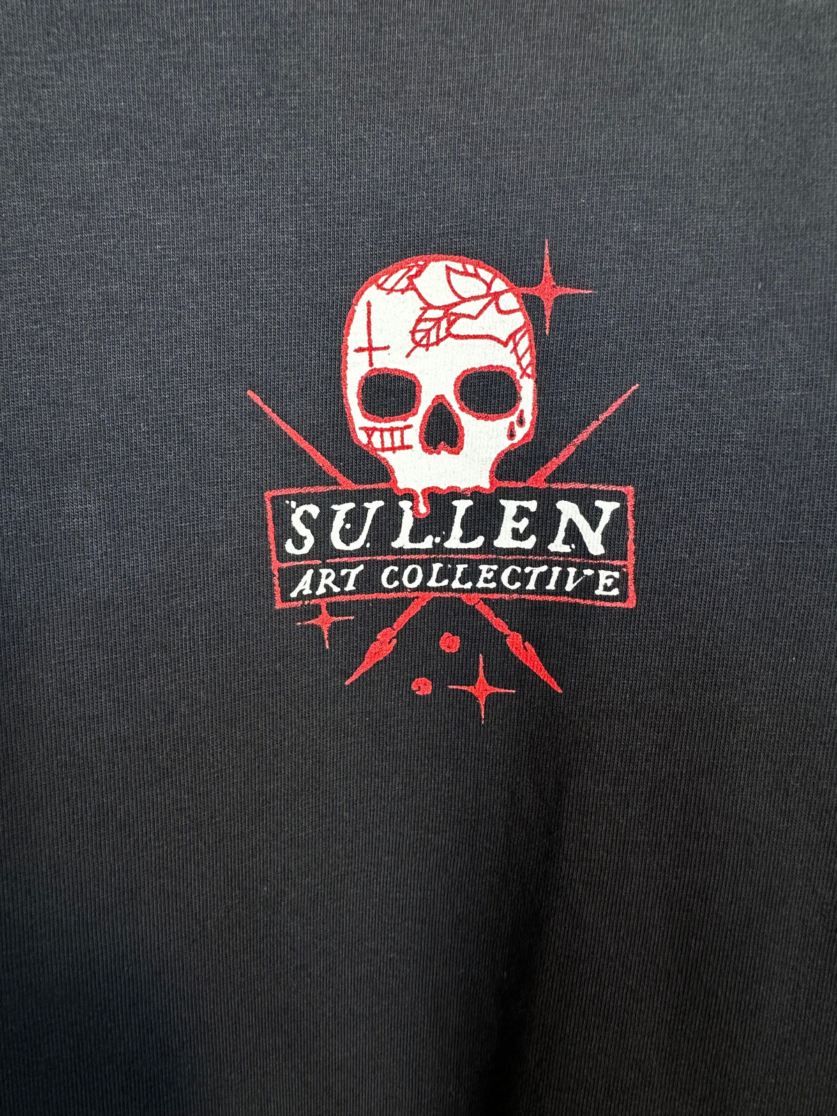 Trestles Clothing Company black cotton oversized tee featuring a red and white tattoo-inspired skull graphic