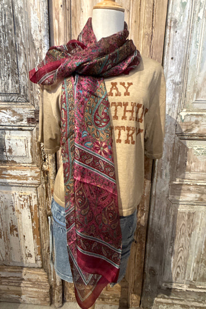 Trestles Clothing Company silk boho scarf in vibrant magenta and paisley prints draped over a mannequin