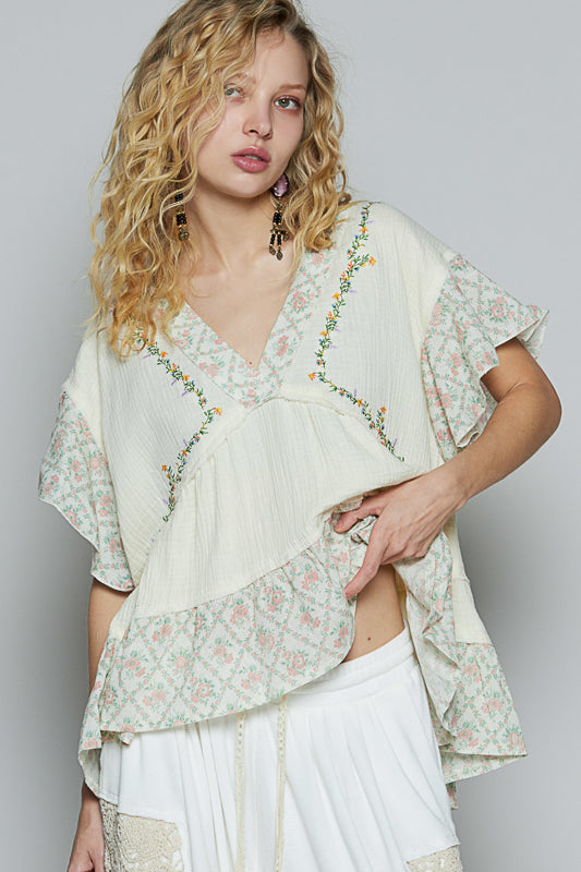 Trestles Clothing Company boho V-neck top in cream double gauze with floral ruffle sleeves and delicate embroidery.