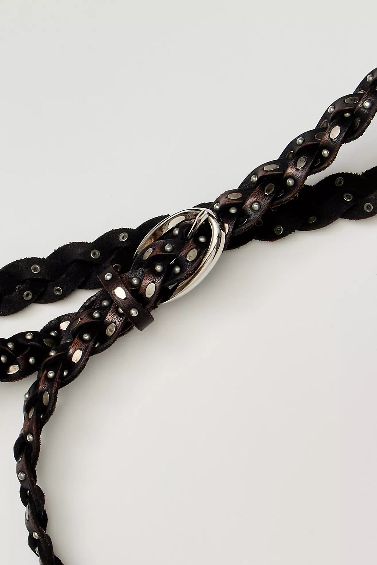Trestles Clothing Company brown braided leather belt featuring silver metal studs and a polished buckle