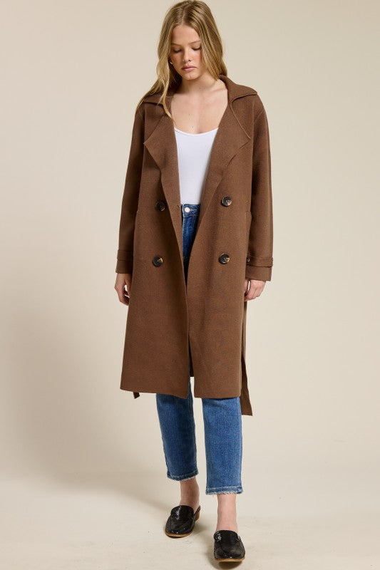 Model wearing Trestles Clothing Company brown midi-length cashmere blend sweater coat with double-breasted buttons
