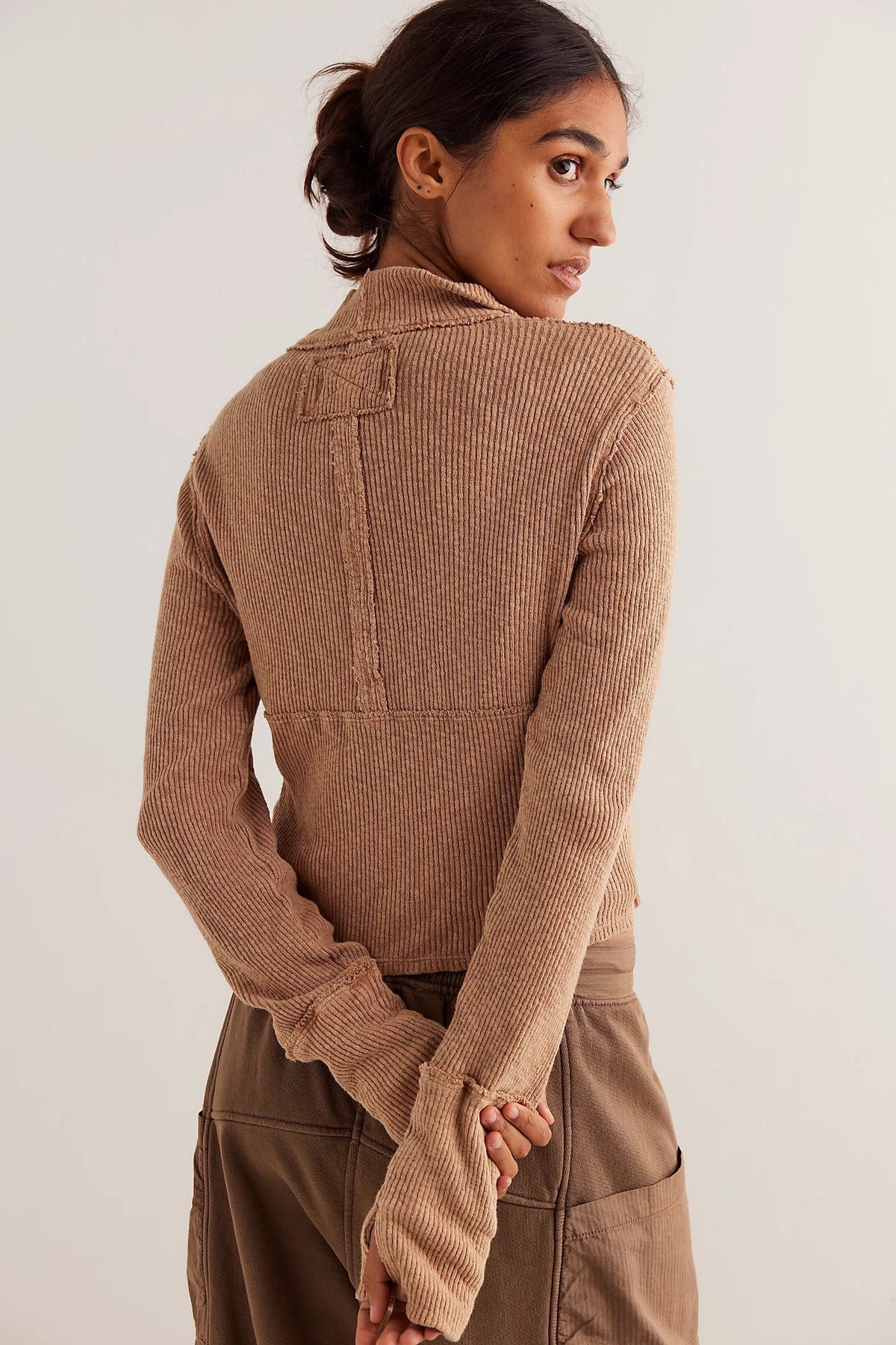 Trestles Clothing Company brown ribbed knit half-zip top with exposed seams and long sleeves, back view