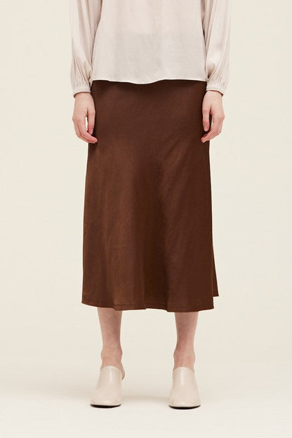 Trestles Clothing Company brown midi-length fit and flare satin skirt with an elastic waistband