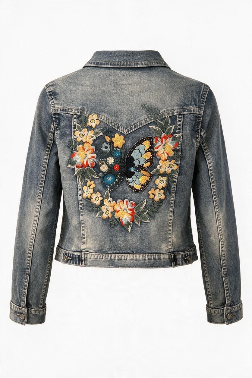 Trestles Clothing Company vintage wash denim jacket featuring back embroidery of a butterfly and colorful flowers.