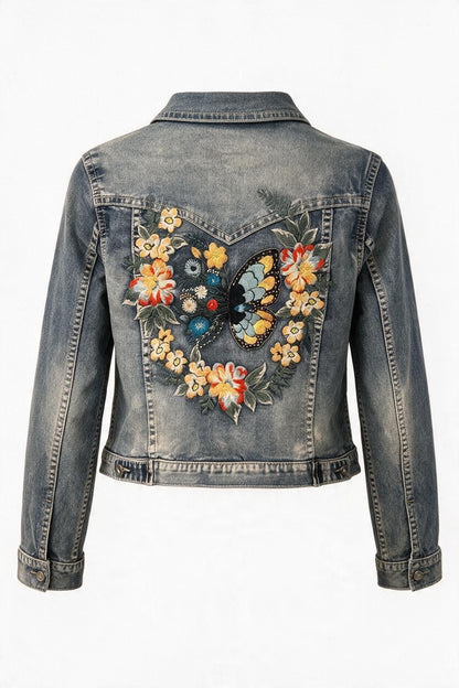 Trestles Clothing Company vintage wash denim jacket featuring back embroidery of a butterfly and colorful flowers.