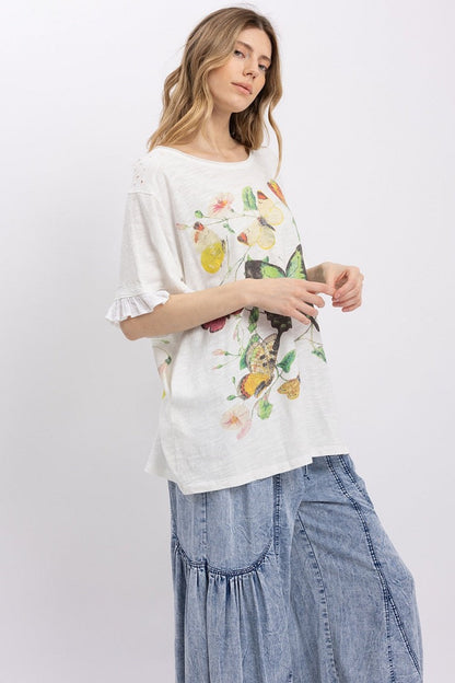 Trestles Clothing Company white cotton tee with butterfly graphic, ruffled sleeves, and relaxed boho fit on a model.