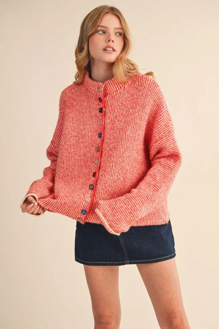 Trestles Clothing Company cozy red knit sweater with unique mismatched buttons worn by a model in a studio setting