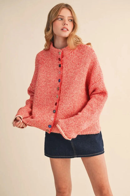 Trestles Clothing Company cozy red knit sweater with unique mismatched buttons worn by a model in a studio setting