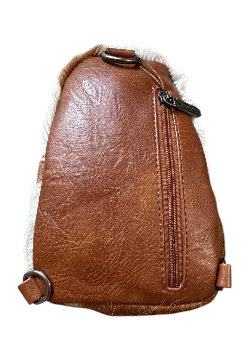Trestles Clothing Company Western sling bag featuring brown PU leather and unique natural hair-on cowhide accents.