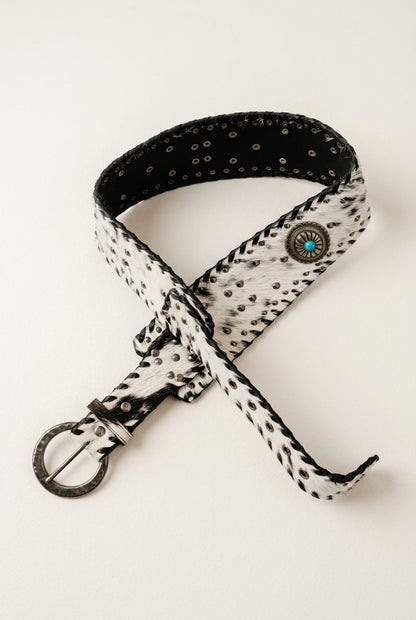Trestles Clothing Company wide cowhide belt with black and white hair-on leather, turquoise conchos, and metal studs.