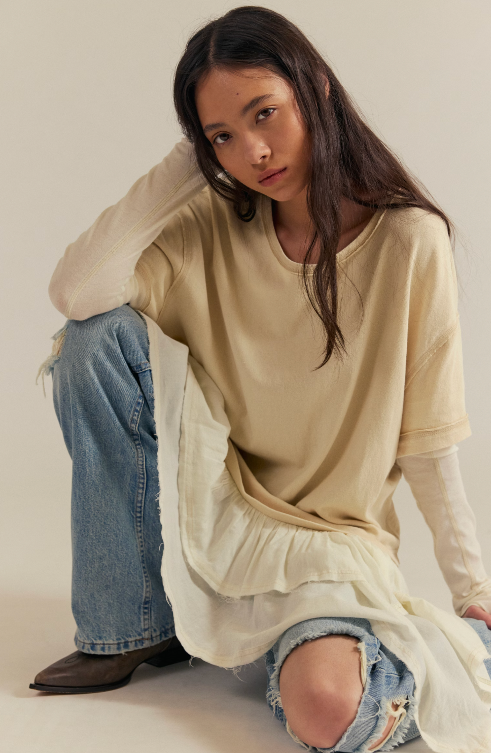 Trestles Clothing Company Tattered Love Tee featuring a cream layered knit top with a peplum hem worn with denim jeans