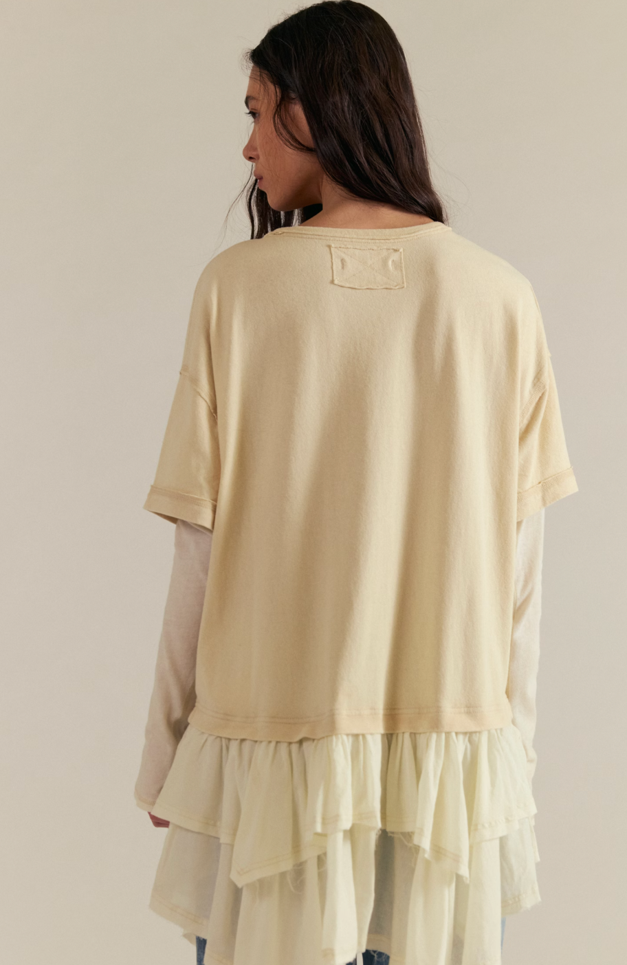 Trestles Clothing Company Tattered Love Tee in cream, featuring a relaxed knit top with a layered peplum hem.